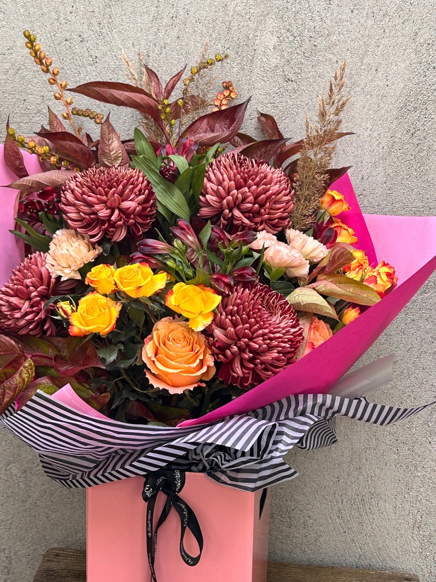 All is Orange bouquet featuring vibrant seasonal blooms and rich colors in a stunning handcrafted arrangement.