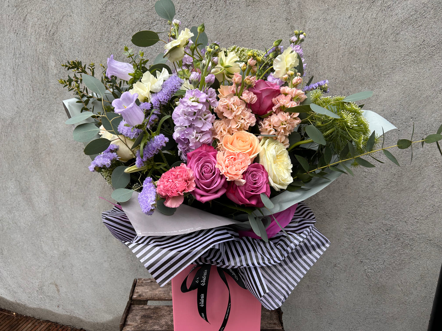 Sea Breeze bouquet featuring cool lilacs, pale blues, creamy whites, and silvery greens in elegant arrangement.