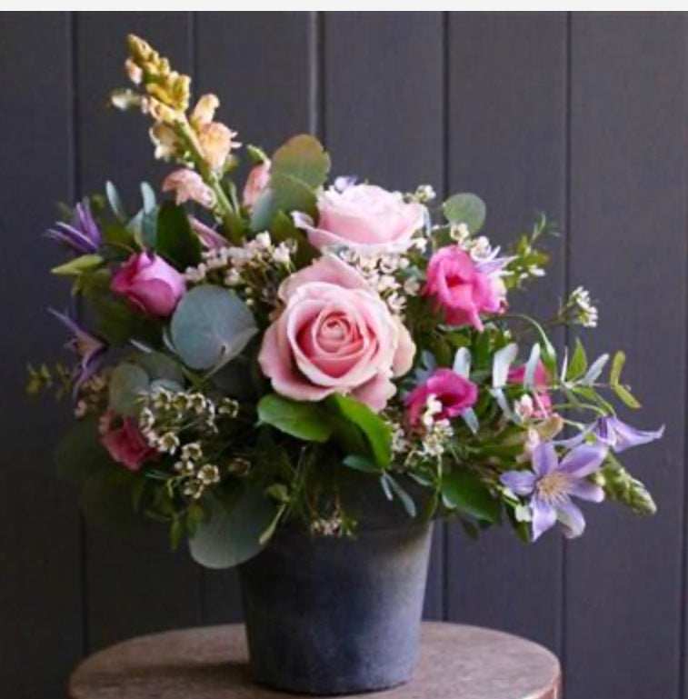 clay pot full of vintage flowers